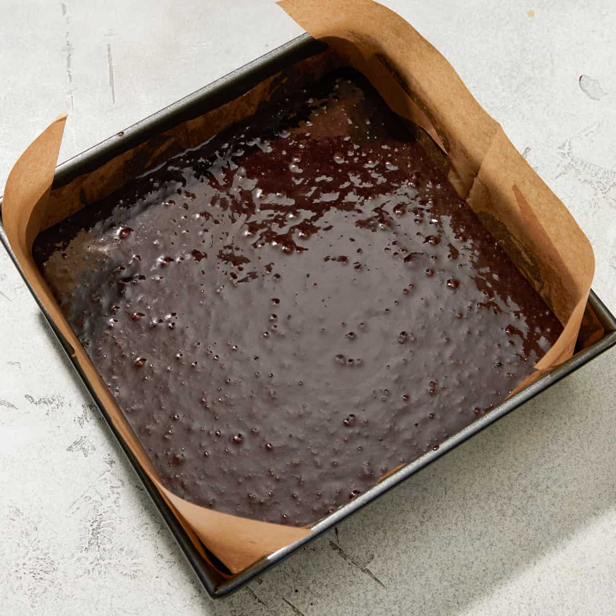 unbaked brownie batter in a pan.