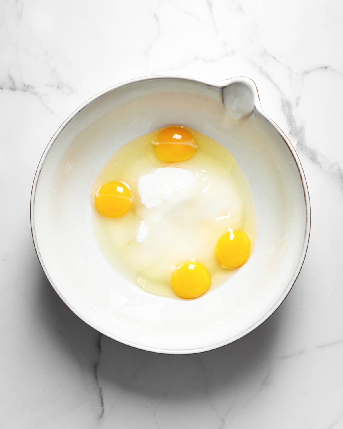 eggs and sugar in a bowl.