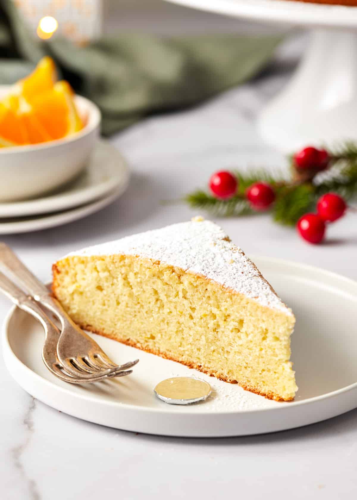 slice of vasilopita on a plate with a coin.