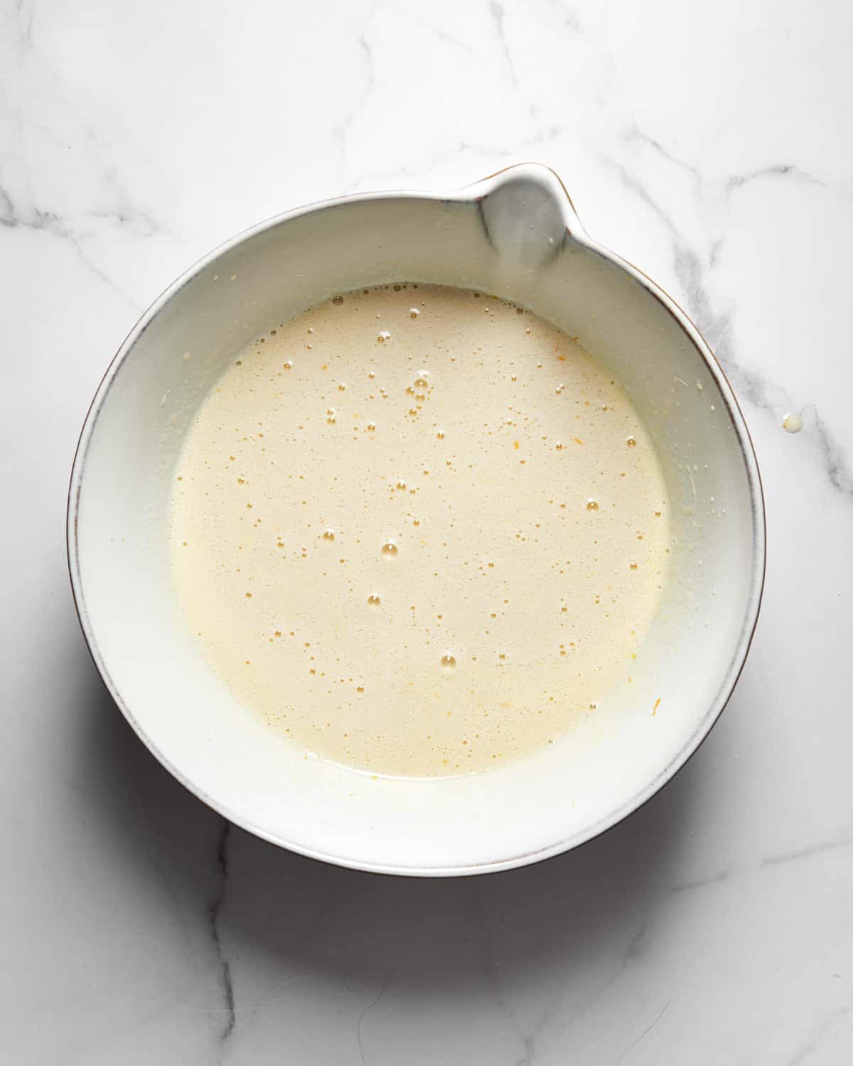 vasilopita cake batter in a mixing bowl.