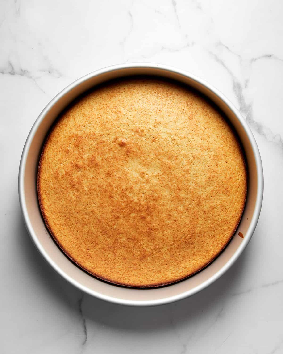 baked vasilopita in a cake pan.