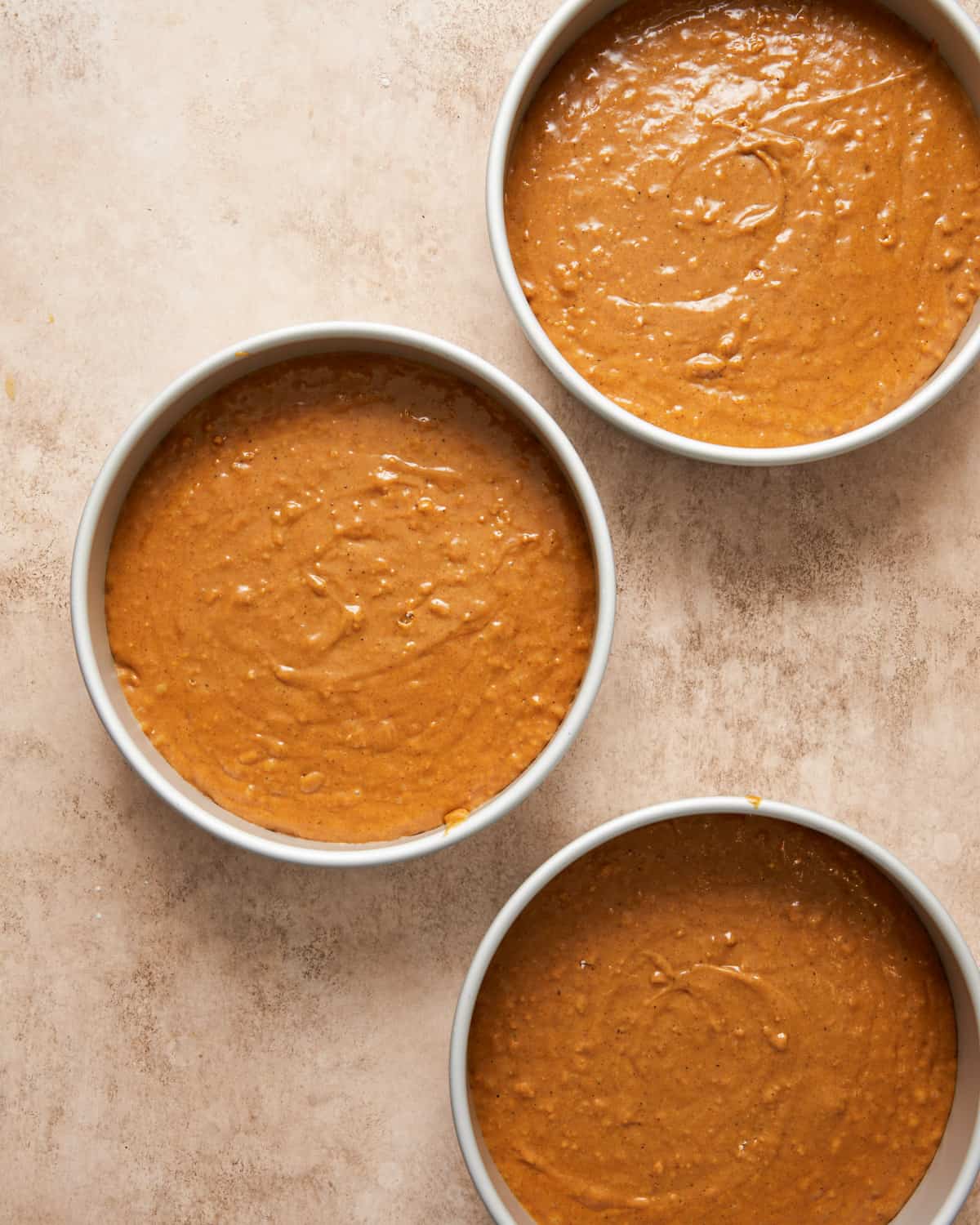 gingerbread cake batter in pans,