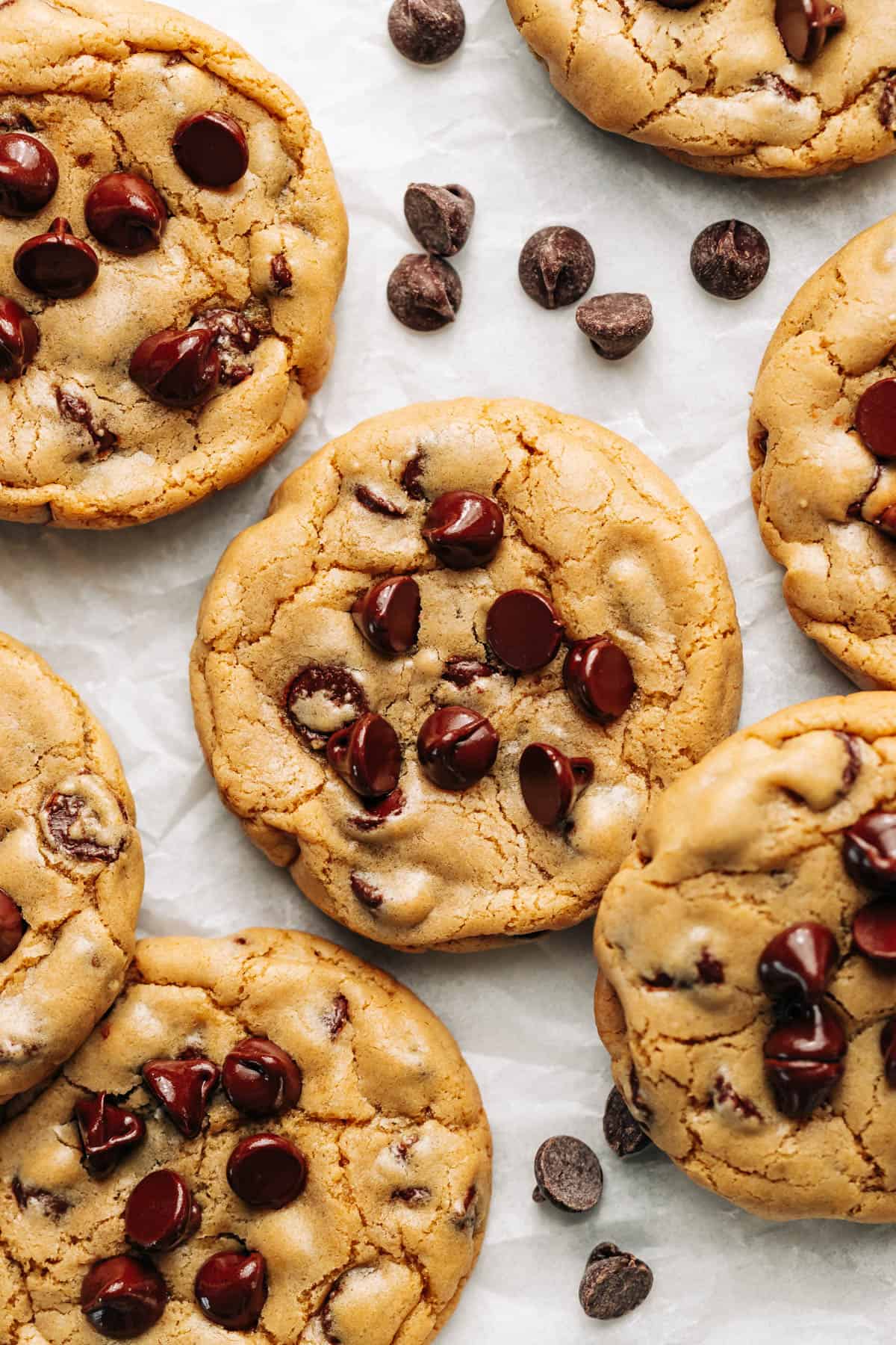 Butterless Chocolate Chip Cookies arranged on parchment paper.