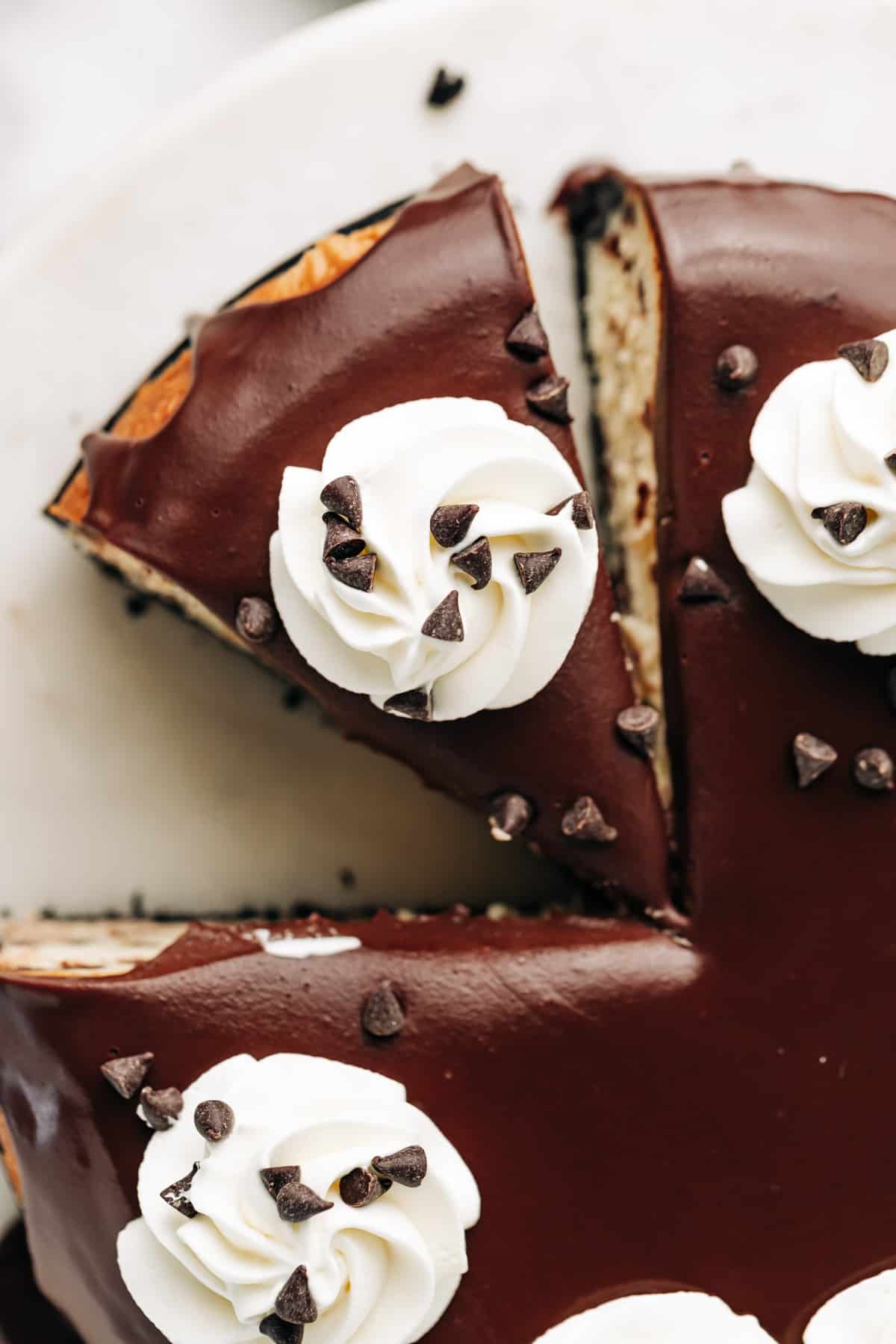 ganache topping on a chocolate chip cheesecake.