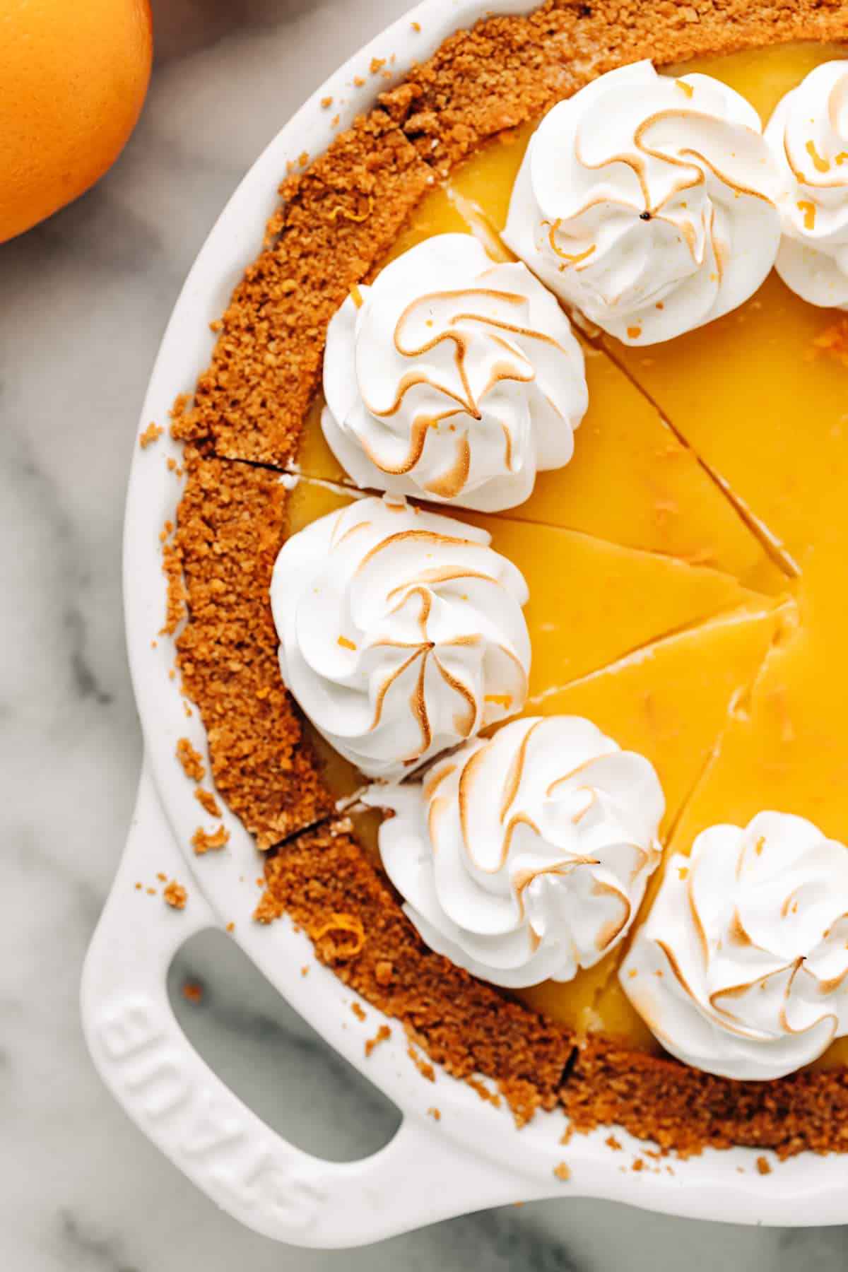 orange pie cut up into slices.