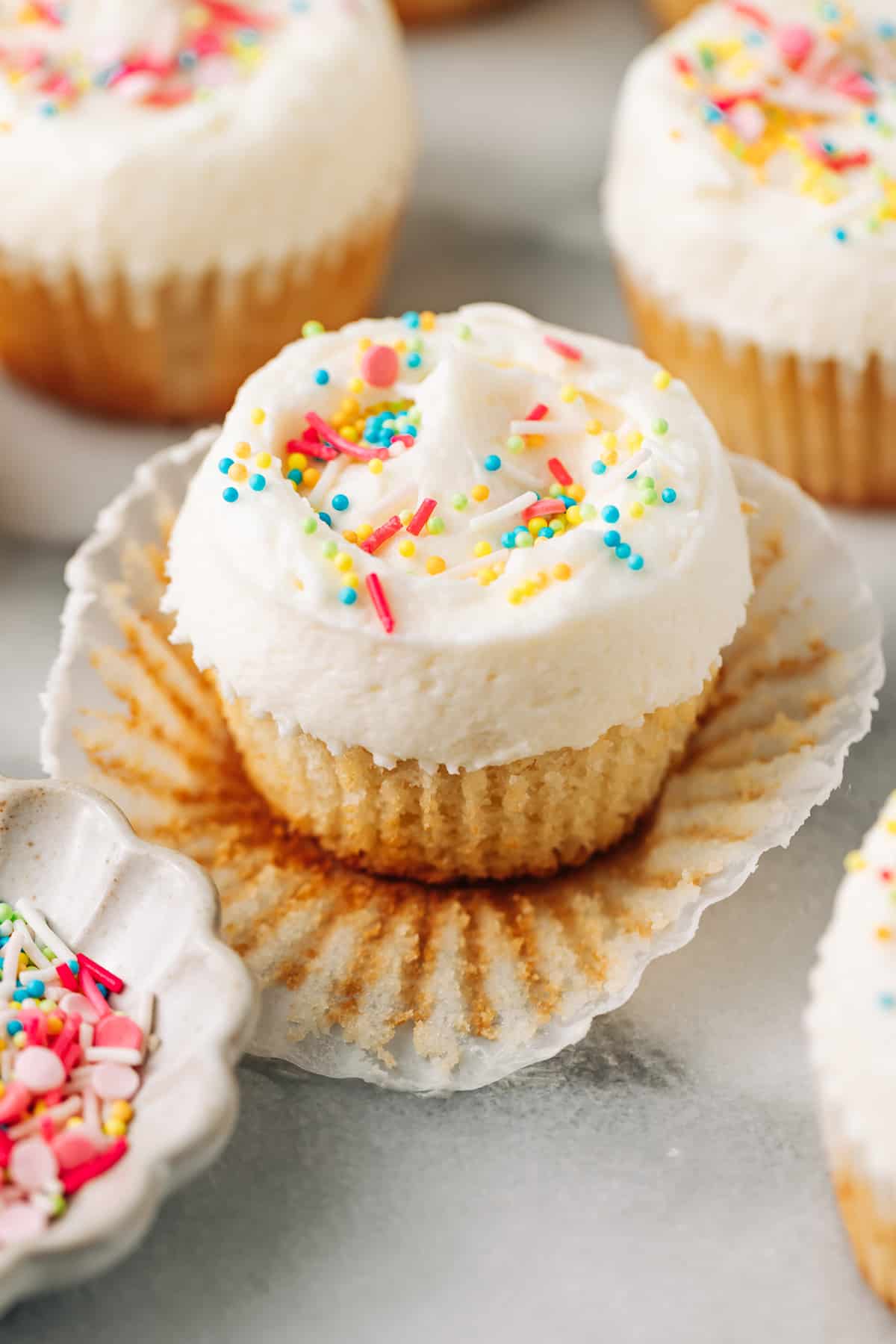vanilla cupcake with buttercream and sprinkles.