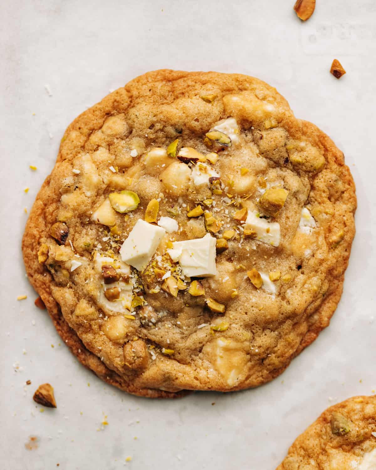 pistachio white chocolate cookie on parchment paper.